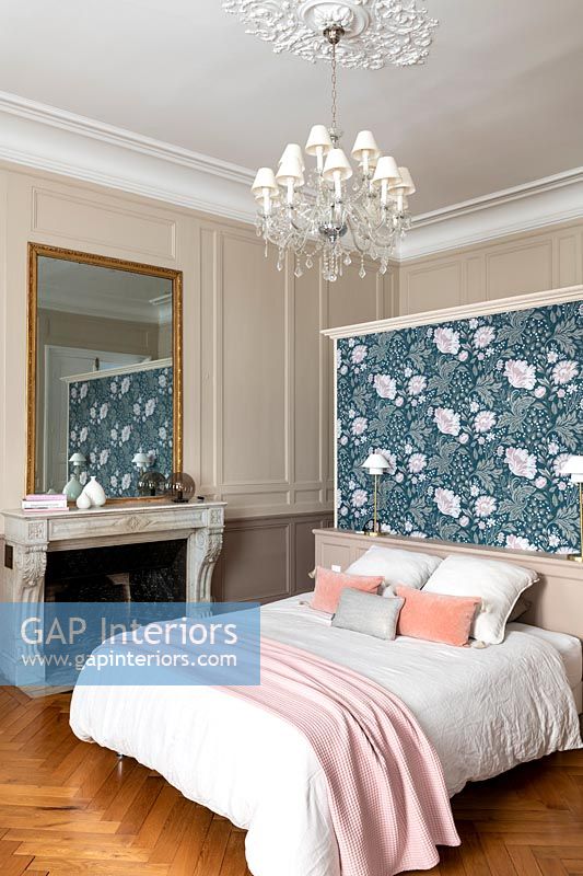 Floral feature wall at head of bed in classic bedroom 