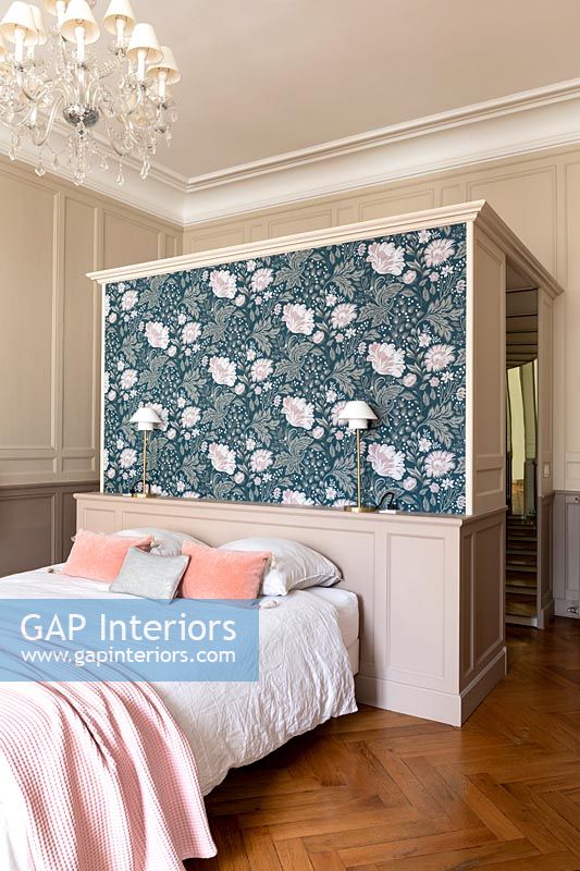 Floral wallpaper on feature wall behind bed in classic bedroom 