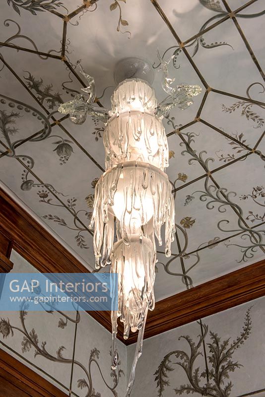 Patterned ceiling and drip effect chandelier 