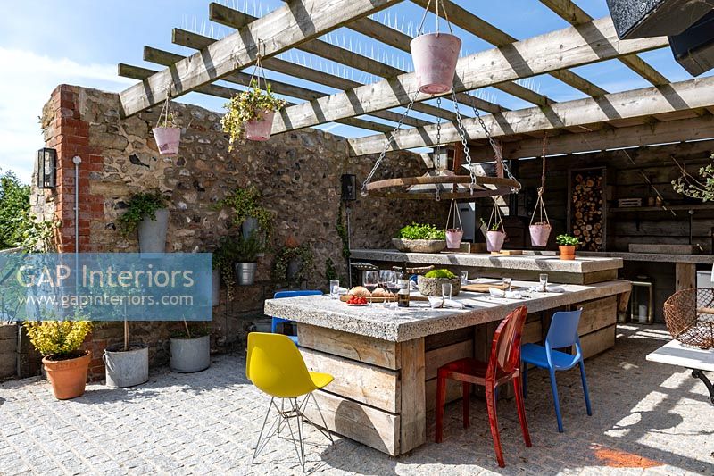 Outdoor dining table under pergola on terrace 