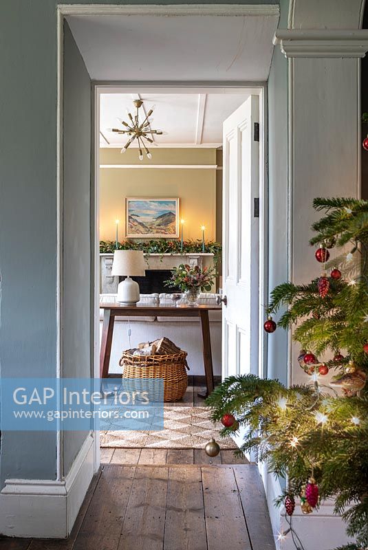 Decorated Christmas tree in country hallway 