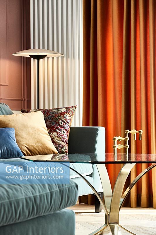 Blue sofa and orange curtains in modern living room 