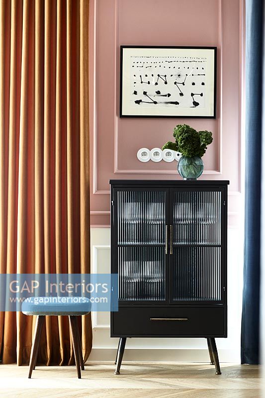 Small black cabinet and stool in modern hallway 