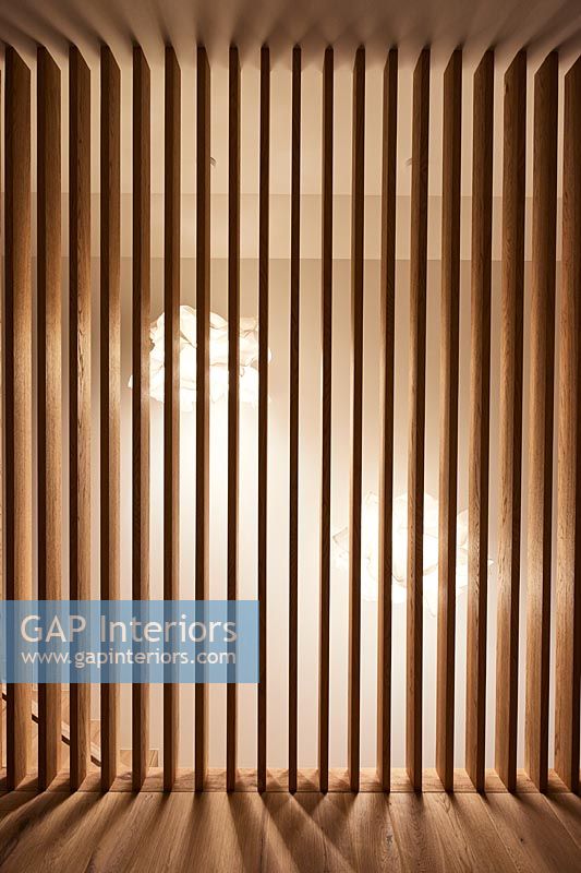 Wooden slats on upstairs landing at top of stairs - view to lighting 
