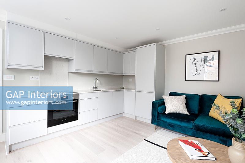 Pale grey modern kitchen in open plan living space 