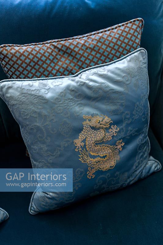 Blue and gold cushion with dragon motif 