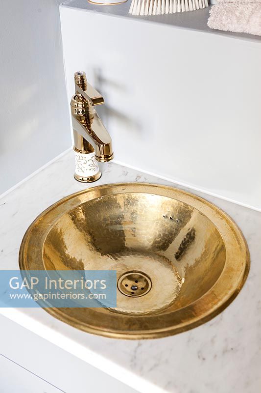 Small gold sink and vintage style faucet 