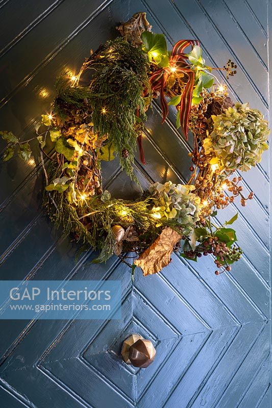 Christmas wreath on door - covered with fairy lights 