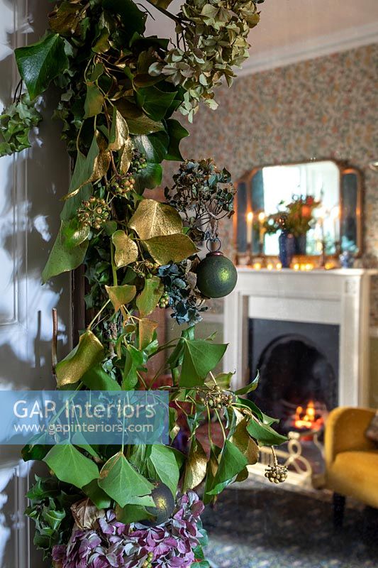 Detail of Christmas garland with living room in background 