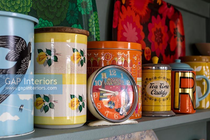 Colourful storage jars on kitchen shelf 