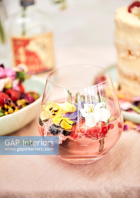 Drink filled with fruit and edible flowers 
