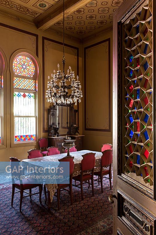 Classic dining room with stained glass windows and decorative ceilings 