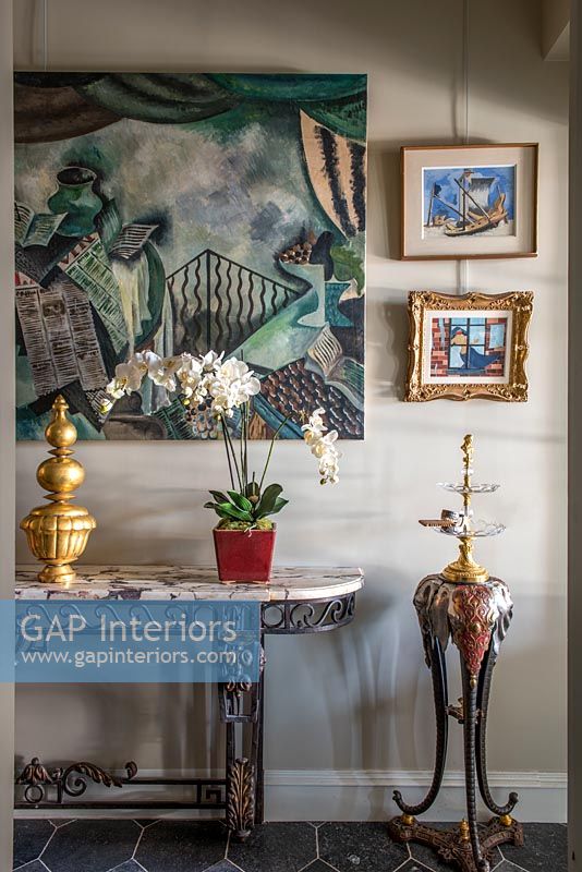 Eclectic hallway with paintings and ornaments 