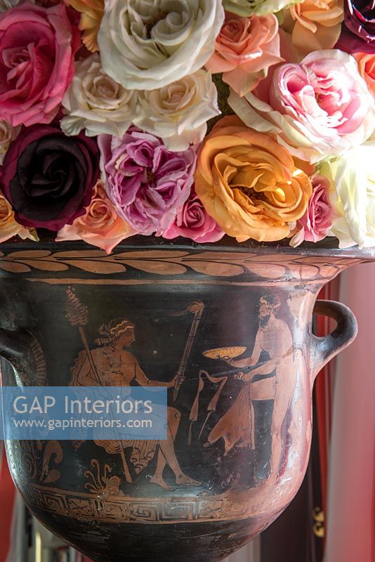 Detail of vintage roses in classical urn 