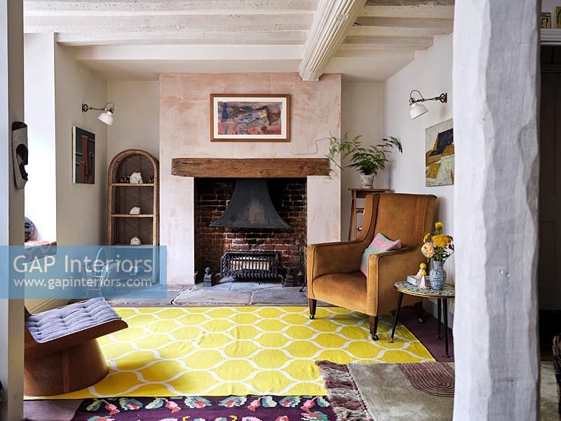 Country living room with modern yellow rug 