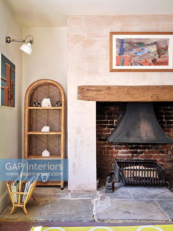 Fireplace in country living room with bare plaster wall