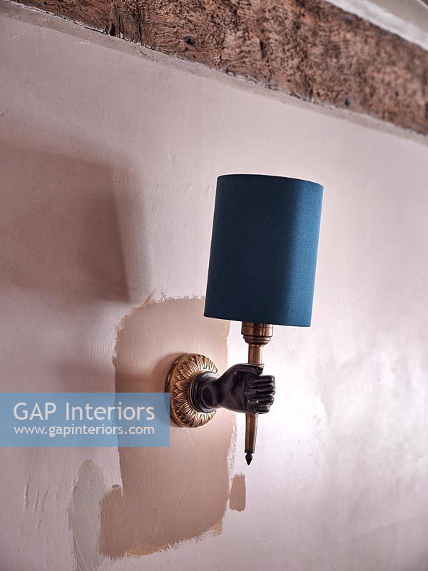 Wall mounted lamp with metal hand detail 