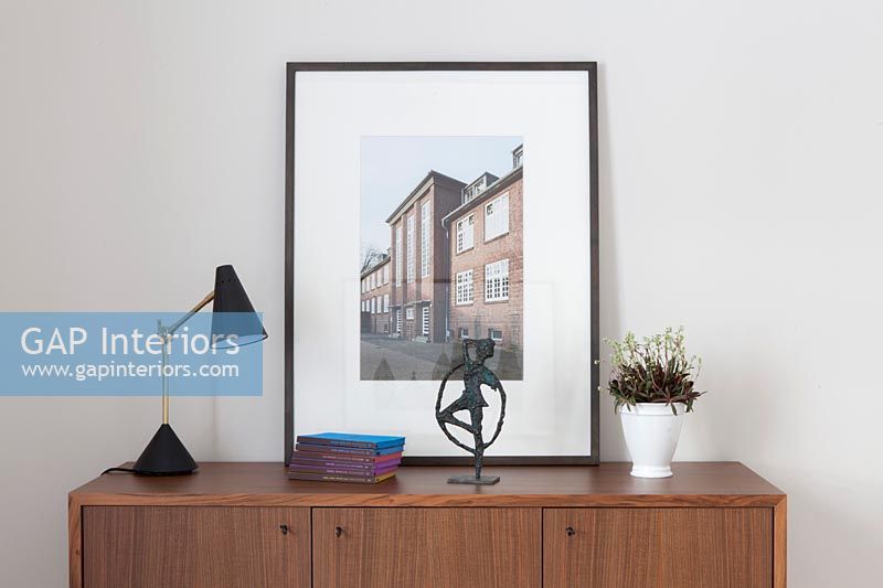Wooden sideboard with framed photograph