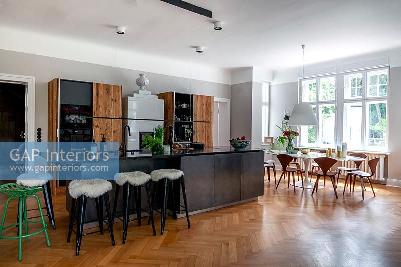 Modern open plan kitchen-diner with parquet flooring 