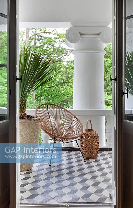 View of modern balcony with wicker chair 