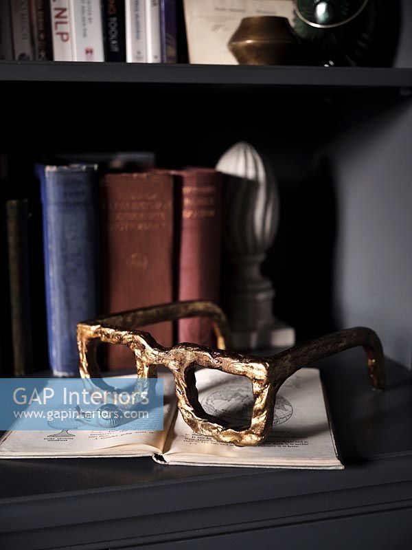 Gold spectacles ornament on open book 