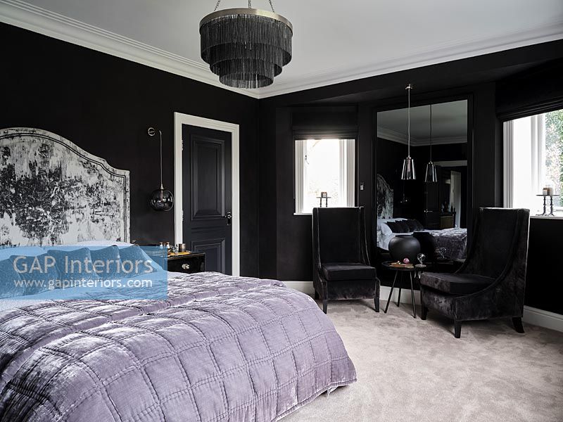 Black and white bedroom with purple bedspread 