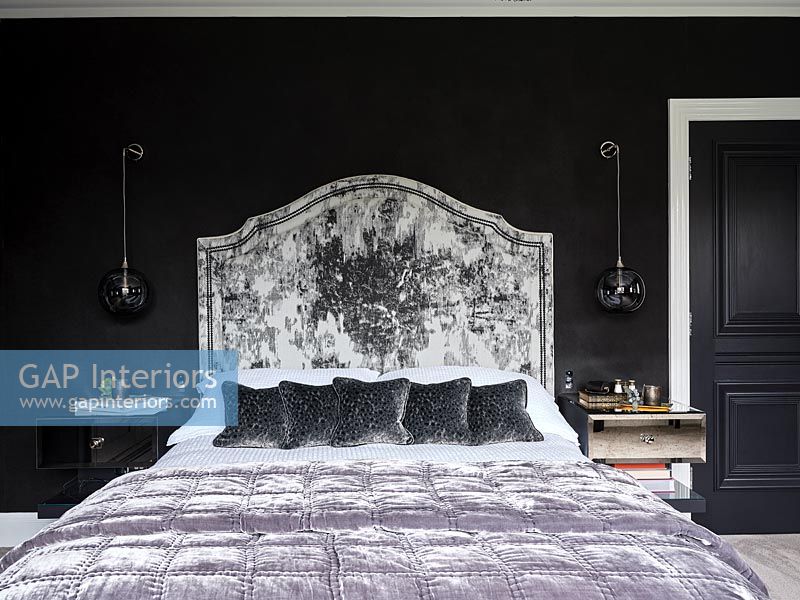Black and white bedroom with purple bedspread 