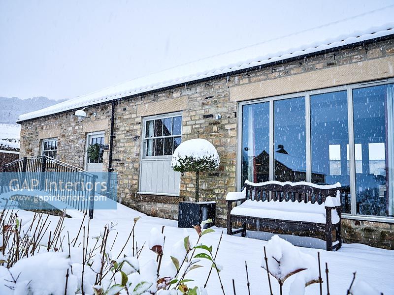 Exterior of country house in snow 