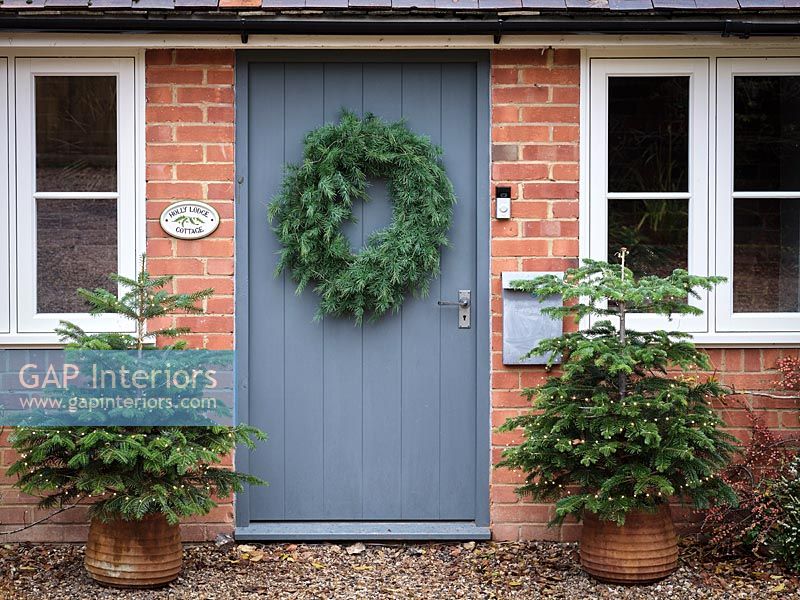 Large green wreath on front door of country house