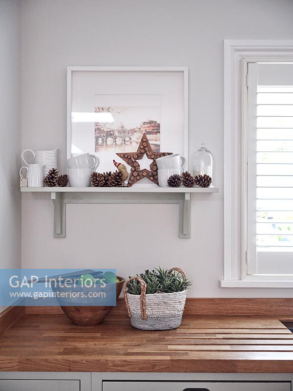 Pinecones and decorative star on kitchen shelf - detail 