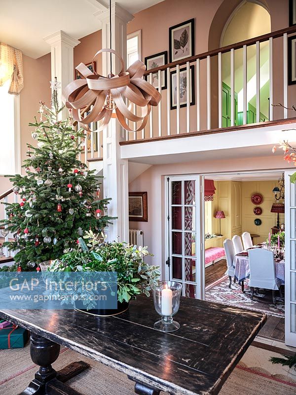 Classic style hallway with open front door and Christmas tree 