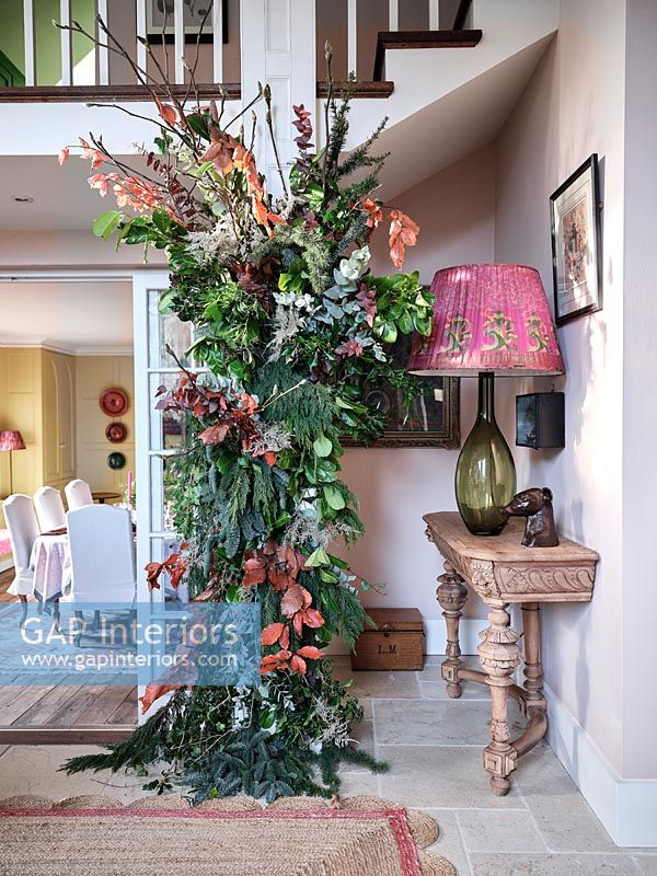 Large garland of plants and flowers in classic style hallway 