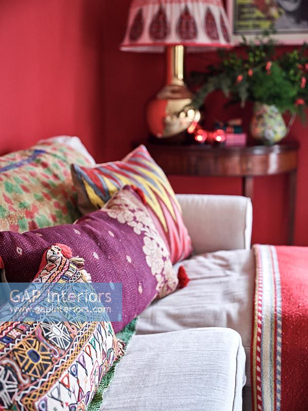 Detail of colourfully patterned cushions on sofa 