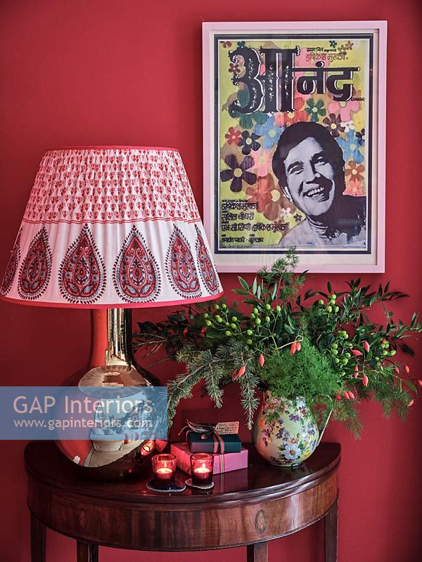Colourful Indian fabric lampshade and Christmas display on console table 