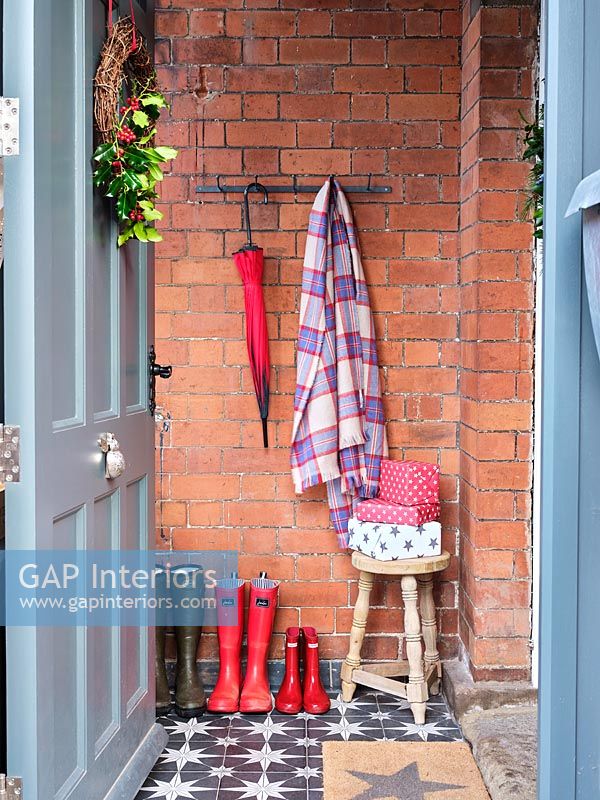 View into small entrance hallway with Christmas gifts on tiny stool 