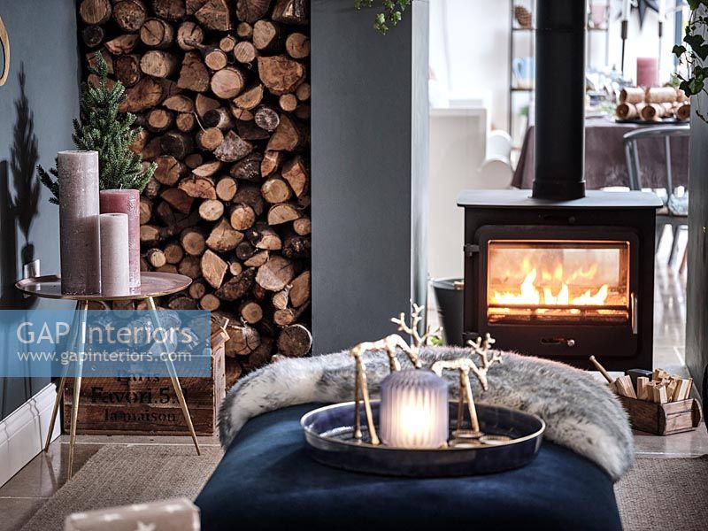 Modern living room with lit wood burner decorated for Christmas 