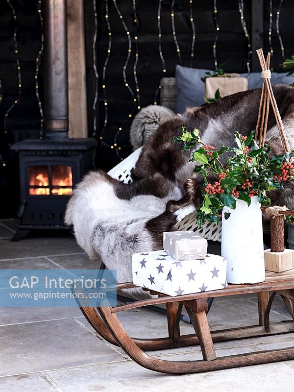 Christmas gifts on wooden sledge in outdoor living area 