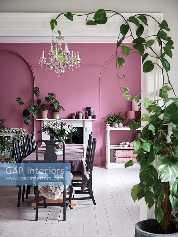 View into dining room with pink painted walls and white floor