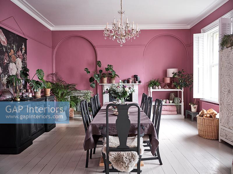 Modern dining room with pink painted walls and white floor