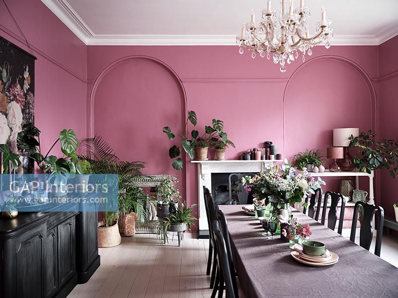 Modern dining room with pink painted walls and black furniture 