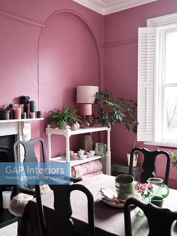 Modern dining room with pink painted walls 