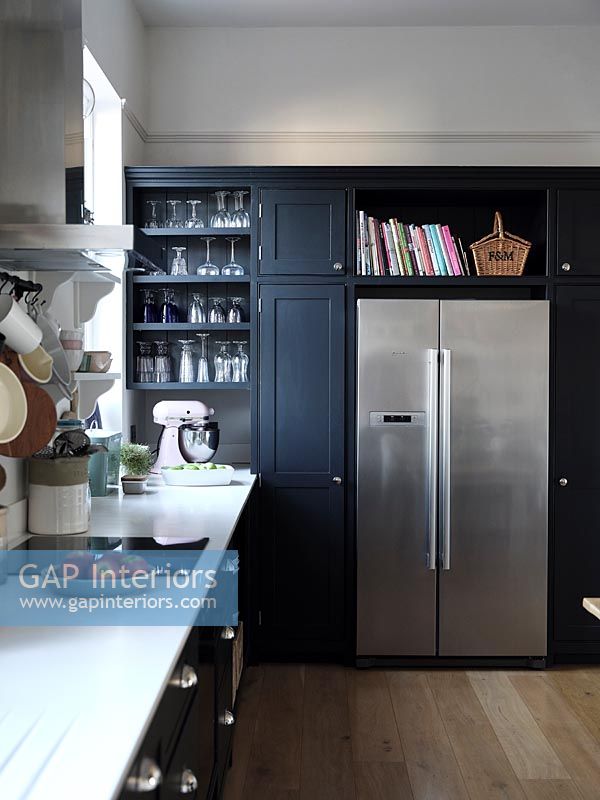 Dark blue painted unit with large stainless steel fridge freezer 