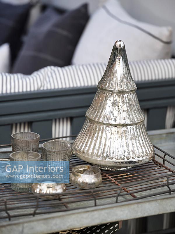 Detail of silver Christmas decorations and tealight holders 
