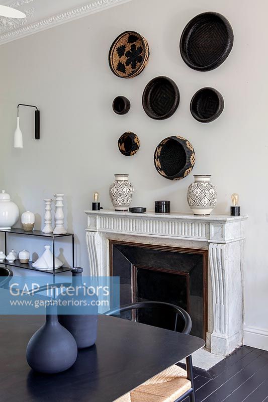Display of baskets on wall above fireplace 