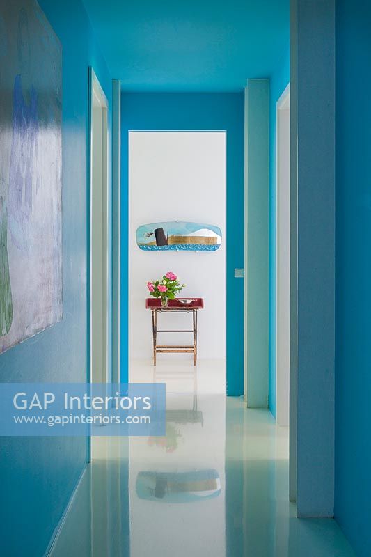 Bright turquoise painted corridor 