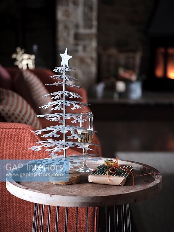 Small silver Christmas tree on side table