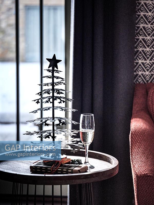 Small silver Christmas tree on side table