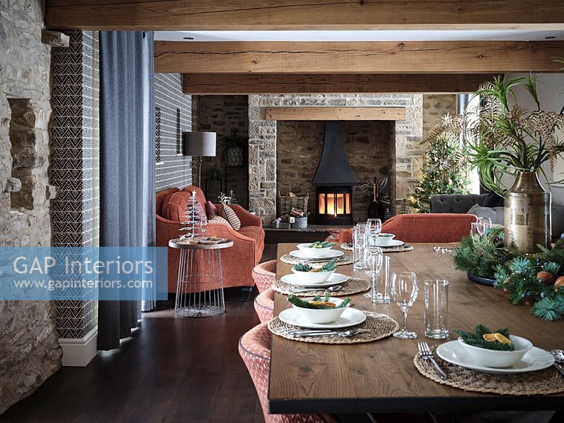 Dining table in open plan living space decorated for Christmas 