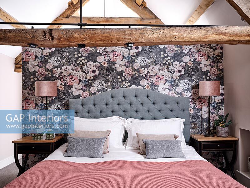 Floral feature wall behind bed in country bedroom 