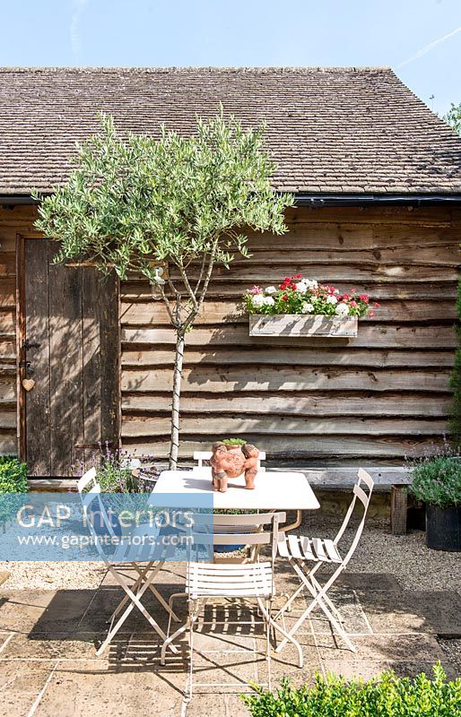 Small cafe style table and chairs in country garden 